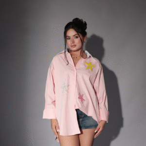 Model wearing an oversized embroidered pink shirt in pink with starfish beadwork – casual cotton outfit