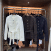 Elegant tweed jackets in white, dark brown, and black, designed to add sophistication and style to any outfit.