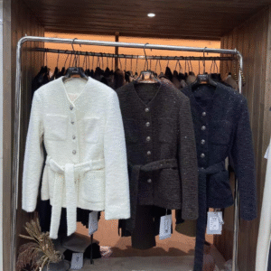 Elegant tweed jackets in white, dark brown, and black, designed to add sophistication and style to any outfit.